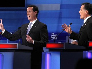 Republican presidential candidates Santorum and Romney discuss a point during a Republican presidential candidates debate in Myrtle Beach