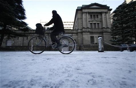 Man cycles in front of BOJ headquarters covered with snow in Tokyo Man cycles in front of BOJ headquarters covered with snow in Tokyo