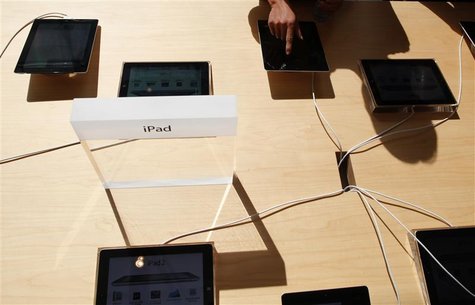 A person tries out an Apple iPad 2 at the company's new store in Nanjing Road, Shanghai A person tries out an Apple iPad 2 at the company's new store in Nanjing Road, Shanghai