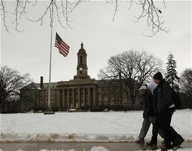 Students pass by a U.S. flag at half-staff at Penn State University in State College Pennsylvania in honor of Joe Paterno Students pass by a U.S. flag at half-staff at Penn State University in State College Pennsylvania in honor of Joe Paterno