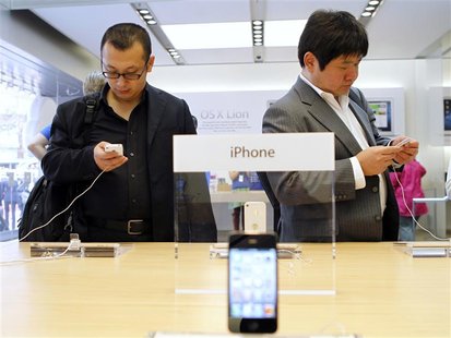 Customers try out the iPhone 4S at the Apple retail store in San Francisco Customers try out the iPhone 4S at the Apple retail store in San Francisco