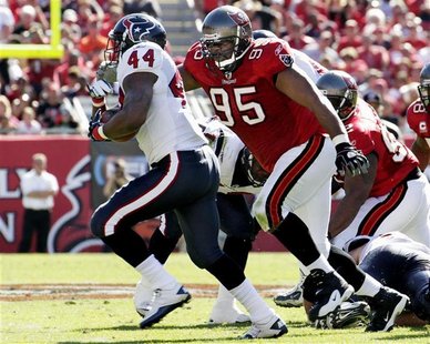 Tampa Bay Buccaneers defensive lineman Albert Haynesworth chases Houston Texans running back Ben Tate during their NFL football game in Tamp Tampa Bay Buccaneers defensive lineman Albert Haynesworth chases Houston Texans running back Ben Tate during their NFL football game in Tamp