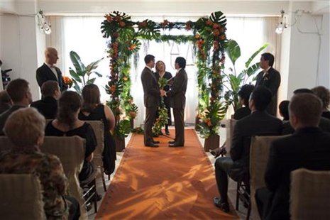 Fung holds hands with Klein, life-partner of 18 years, during their marriage ceremony on the 61st floor of the Empire State Building in New Fung holds hands with Klein, life-partner of 18 years, during their marriage ceremony on the 61st floor of the Empire State Building in New