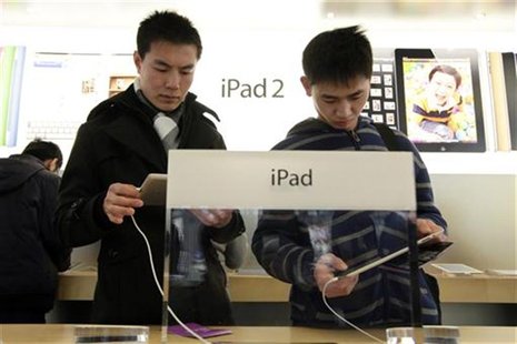 Customers test out Apple iPads in the company's flagship store in Beijing's Sanlitun Area Customers test out Apple iPads in the company's flagship store in Beijing's Sanlitun Area