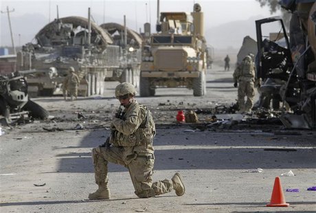 A U.S. soldier keeps watch at the site of an explosion in Kandahar A U.S. soldier keeps watch at the site of an explosion in Kandahar