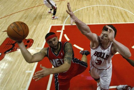 New Jersey Nets' Deron Williams goes to the basket against Chicago Bulls' Omer Asik during the first half of their NBA basketball game in Ch New Jersey Nets' Deron Williams goes to the basket against Chicago Bulls' Omer Asik during the first half of their NBA basketball game in Ch