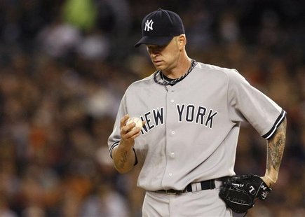 New York Yankees Burnett pauses while pitching to the Detroit Tigers during the first inning of Game 4 in their MLB American League Division New York Yankees Burnett pauses while pitching to the Detroit Tigers during the first inning of Game 4 in their MLB American League Division