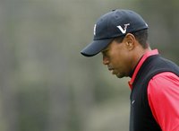 Woods reacts after missing birdie on the 13th hole during the final round of the Pebble Beach National Pro-Am
