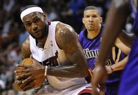 Miami Heat's LeBron James is defended Sacramento Kings' Isaiah Thomas during the first half of their NBA basketball game in Miami