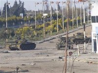 Syrian tanks are seen in Bab Amro near the city of Hom