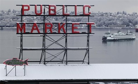 Snow blankets the roof of the famous Pike Place Market as a ferry floats past in Seattle Snow blankets the roof of the famous Pike Place Market as a ferry floats past in Seattle