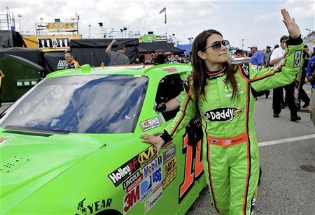 NASCAR Sprint Cup Series driver Danica Patrick (R) waves to fans while rolling her number 10 car out to the track before a practice session for the Daytona 500 at Daytona International Speedway in Daytona Beach, Florida