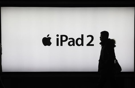 A man walks past an iPad 2 advertisement in Shanghai A man walks past an iPad 2 advertisement in Shanghai