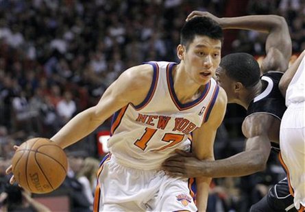 New York Knicks' Jeremy Lin dribbles the ball as Miami Heat's Norris Cole defends during the second half of their NBA basketball game in Mia New York Knicks' Jeremy Lin dribbles the ball as Miami Heat's Norris Cole defends during the second half of their NBA basketball game in Mia