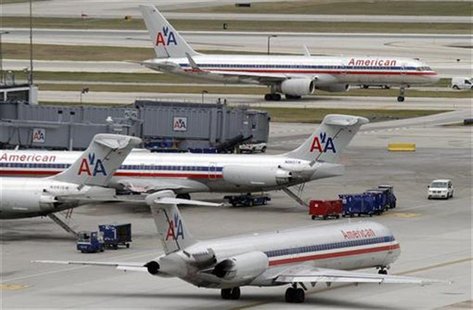American Airlines planes sit at their gates while others taxi for arrival and departure at O'Hare International airport in Chicago American Airlines planes sit at their gates while others taxi for arrival and departure at O'Hare International airport in Chicago