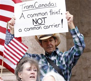Man holds sign at rally as landowner Crawford is set to battle TransCanada over trenching of her property for the Keystone pipeline in Paris Man holds sign at rally as landowner Crawford is set to battle TransCanada over trenching of her property for the Keystone pipeline in Paris