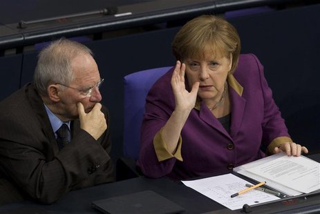 German Chancellor Merkel talks with Finance Minister Schaeuble during debate before parliamentary vote on Greek bailout package in Bundestag German Chancellor Merkel talks with Finance Minister Schaeuble during debate before parliamentary vote on Greek bailout package in Bundestag