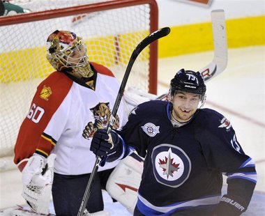 Winnipeg Jets' Wellwood celebrates a Jets goal on Florida Panthers goaltender Theodore during the third period of their NHL hockey game in W Winnipeg Jets' Wellwood celebrates a Jets goal on Florida Panthers goaltender Theodore during the third period of their NHL hockey game in W