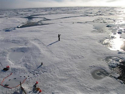 A member of a team of Cambridge scientists trying to find out why Arctic sea ice is melting so fast, walks on some drift ice 500 miles from A member of a team of Cambridge scientists trying to find out why Arctic sea ice is melting so fast, walks on some drift ice 500 miles from