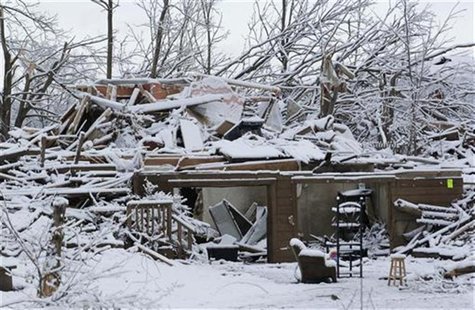 Snow covers a storm-damaged home in Henryville Snow covers a storm-damaged home in Henryville