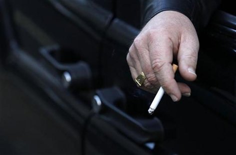 A man smokes in his car in London A man smokes in his car in London