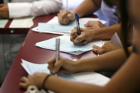 Applicants fill out forms during a job fair at the Southeast LA-Crenshaw WorkSource Center in Los Angeles. Applicants fill out forms during a job fair at the Southeast LA-Crenshaw WorkSource Center in Los Angeles.