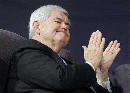 U.S. Republican presidential candidate Newt Gingrich applauds after the choir performed before speaking at First Redeemer Church while on a U.S. Republican presidential candidate Newt Gingrich applauds after the choir performed before speaking at First Redeemer Church while on a