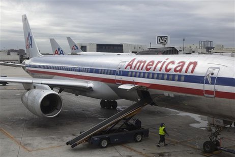 A worker walks underneath an American Airlines airplane at Miami International airport in Miami, Florida A worker walks underneath an American Airlines airplane at Miami International airport in Miami, Florida