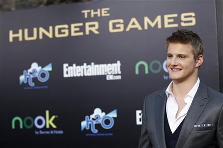 Cast member Alexander Ludwig poses at the premiere of ''The Hunger Games'' at Nokia theatre in Los Angeles, California March 12, 2012. Cast member Alexander Ludwig poses at the premiere of ''The Hunger Games'' at Nokia theatre in Los Angeles, California March 12, 2012.