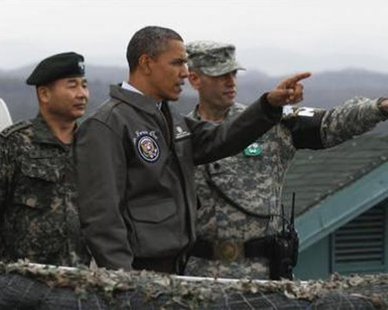 U.S. President Barack Obama visits U.S. military personnel stationed at Observation Post Ouellette along the Demilitarized Zone (DMZ) which borders North and South Korea, outside Seoul, March 25, 2012. U.S. President Barack Obama visited South Korea's tense border with the North on Sunday in a show of solidarity with U.S. ally Seoul and a message of resolve to Pyongyang's new young ruler in his country's nuclear standoff with the West.
Credit: Reuters/Larry Downing U.S. President Barack Obama visits U.S. military personnel stationed at Observation Post Ouellette along the Demilitarized Zone (DMZ) which borders North and South Korea, outside Seoul, March 25, 2012. U.S. President Barack Obama visited South Korea's tense border with the North on Sunday in a show of solidarity with U.S. ally Seoul and a message of resolve to Pyongyang's new young ruler in his country's nuclear standoff with the West.
Credit: Reuters/Larry Downing