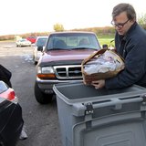 An employee of Access Information Management dumps paper into the shredding bins. (courtesy of Wisconsin Department of Agriculture, Trade and Consumer Protection). An employee of Access Information Management dumps paper into the shredding bins. (courtesy of Wisconsin Department of Agriculture, Trade and Consumer Protection).