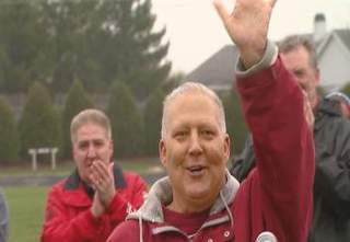 Dan Baker waves to the crowd during the ceremony naming the De Pere high school track after him. (courtesy of FOX 11). Dan Baker waves to the crowd during the ceremony naming the De Pere high school track after him. (courtesy of FOX 11).