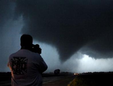 Storm chaser photographer Brad Mack shoots a tornado as it makes its way over the 135 freeway near Moundridge, Kansas, during the third day of severe weather and multiple tornado sightings, April 14, 2012. REUTERS/Gene Blevins Storm chaser photographer Brad Mack shoots a tornado as it makes its way over the 135 freeway near Moundridge, Kansas, during the third day of severe weather and multiple tornado sightings, April 14, 2012. REUTERS/Gene Blevins