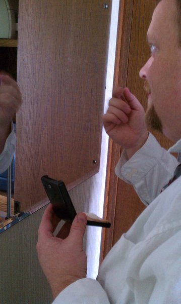 Bryan putting on his make up...actually Nikki's makeup to cover his pimple.