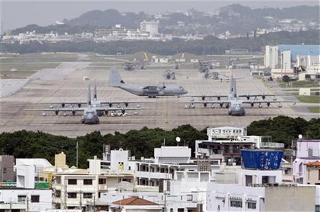 Hercules aircraft are parked on the tarmac at Marine Corps Air Station Futenma in Ginowan on Okinawa May 3, 2010. REUTERS/Issei Kato Hercules aircraft are parked on the tarmac at Marine Corps Air Station Futenma in Ginowan on Okinawa May 3, 2010. REUTERS/Issei Kato