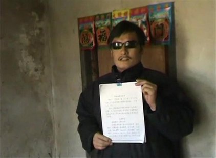 Blind legal activist Chen Guangcheng holds a petition in his village home in Linyi in eastern Shandong province, in this still image taken f Blind legal activist Chen Guangcheng holds a petition in his village home in Linyi in eastern Shandong province, in this still image taken f