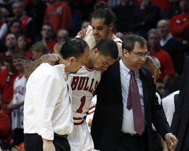 Chicago Bulls' Derrick Rose (C) is helped off the court after getting hurt during the second half of their NBA Eastern Conference quarter-fi Chicago Bulls' Derrick Rose (C) is helped off the court after getting hurt during the second half of their NBA Eastern Conference quarter-fi