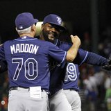 Tampa Bay Rays pitcher Fernando Rodney (R) is congratulated by manager Joe Maddon (L) after making the final out against the Texas Rangers i Tampa Bay Rays pitcher Fernando Rodney (R) is congratulated by manager Joe Maddon (L) after making the final out against the Texas Rangers i