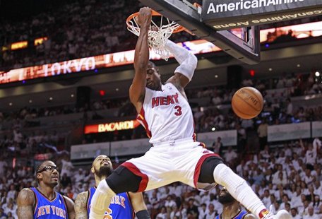 Miami Heat shooting guard Dwyane Wade (R) scores past New York Knicks power forward Amare Stoudemire (L) and Tyson Chandler (C) in the first Miami Heat shooting guard Dwyane Wade (R) scores past New York Knicks power forward Amare Stoudemire (L) and Tyson Chandler (C) in the first