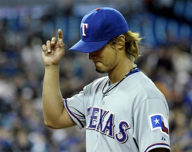 Texas Rangers pitcher Yu Darvish gestures to fans during the second inning of their MLB American League baseball game against the Toronto Bl Texas Rangers pitcher Yu Darvish gestures to fans during the second inning of their MLB American League baseball game against the Toronto Bl
