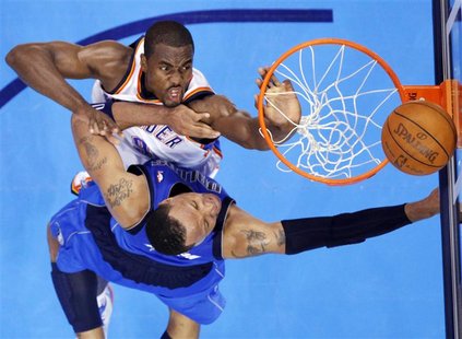 Oklahoma City Thunder's Serge Ibaka (top) contests a shot by Dallas Mavericks' Shawn Marion during the first half of Game 1 of their NBA Wes Oklahoma City Thunder's Serge Ibaka (top) contests a shot by Dallas Mavericks' Shawn Marion during the first half of Game 1 of their NBA Wes