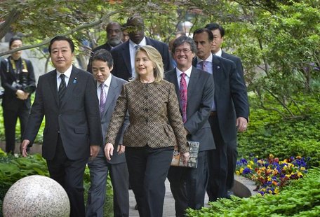 Japan's Prime Minister Yoshihiko Noda (L) and U.S. Secretary of State Hillary Clinton (2nd L) walk together to a reception at the National G Japan's Prime Minister Yoshihiko Noda (L) and U.S. Secretary of State Hillary Clinton (2nd L) walk together to a reception at the National G