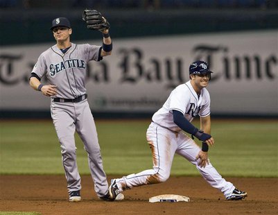 Tampa Bay Rays' Evan Longoria (R) holds his left knee and grimaces after he was tagged out by Seattle Mariners shortstop Brendan Ryan (L) tr Tampa Bay Rays' Evan Longoria (R) holds his left knee and grimaces after he was tagged out by Seattle Mariners shortstop Brendan Ryan (L) tr