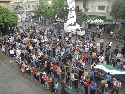 Demonstrators protest against Syria's President Bashar al-Assad in Kafranbel May 1, 2012. The banner reads, "Revolution until victory". REUT Demonstrators protest against Syria's President Bashar al-Assad in Kafranbel May 1, 2012. The banner reads, "Revolution until victory". REUT