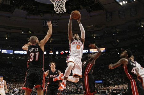 New York Knicks' J.R. Smith (8) drives to the basket for a dunk past Miami Heat's Shane Battier (L) and Joel Anthony (R) during the first ha New York Knicks' J.R. Smith (8) drives to the basket for a dunk past Miami Heat's Shane Battier (L) and Joel Anthony (R) during the first ha