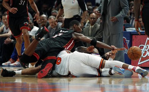 Miami Heat's Chris Bosh (top) dives over New York Knick's J.R. Smith for a loose ball during the second half of Game 3 of their NBA Eastern Miami Heat's Chris Bosh (top) dives over New York Knick's J.R. Smith for a loose ball during the second half of Game 3 of their NBA Eastern