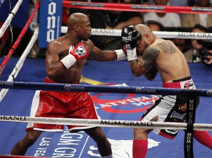 Floyd Mayweather Jr. (L) of the U.S. throws a punch at WBA super welterweight champion Miguel Cotto of Puerto Rico during their title fight Floyd Mayweather Jr. (L) of the U.S. throws a punch at WBA super welterweight champion Miguel Cotto of Puerto Rico during their title fight