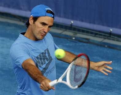 Roger Federer of Switzerland returns the ball during a training session at the Madrid Open tennis tournament in Madrid May 4, 2012. The trad Roger Federer of Switzerland returns the ball during a training session at the Madrid Open tennis tournament in Madrid May 4, 2012. The trad