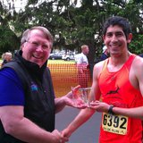Portage native accepts his trophy for winning the 2012 Kalamazoo Marathon 5k