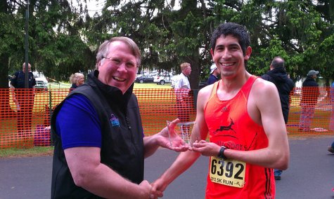 Portage native accepts his trophy for winning the 2012 Kalamazoo Marathon 5k Portage native accepts his trophy for winning the 2012 Kalamazoo Marathon 5k